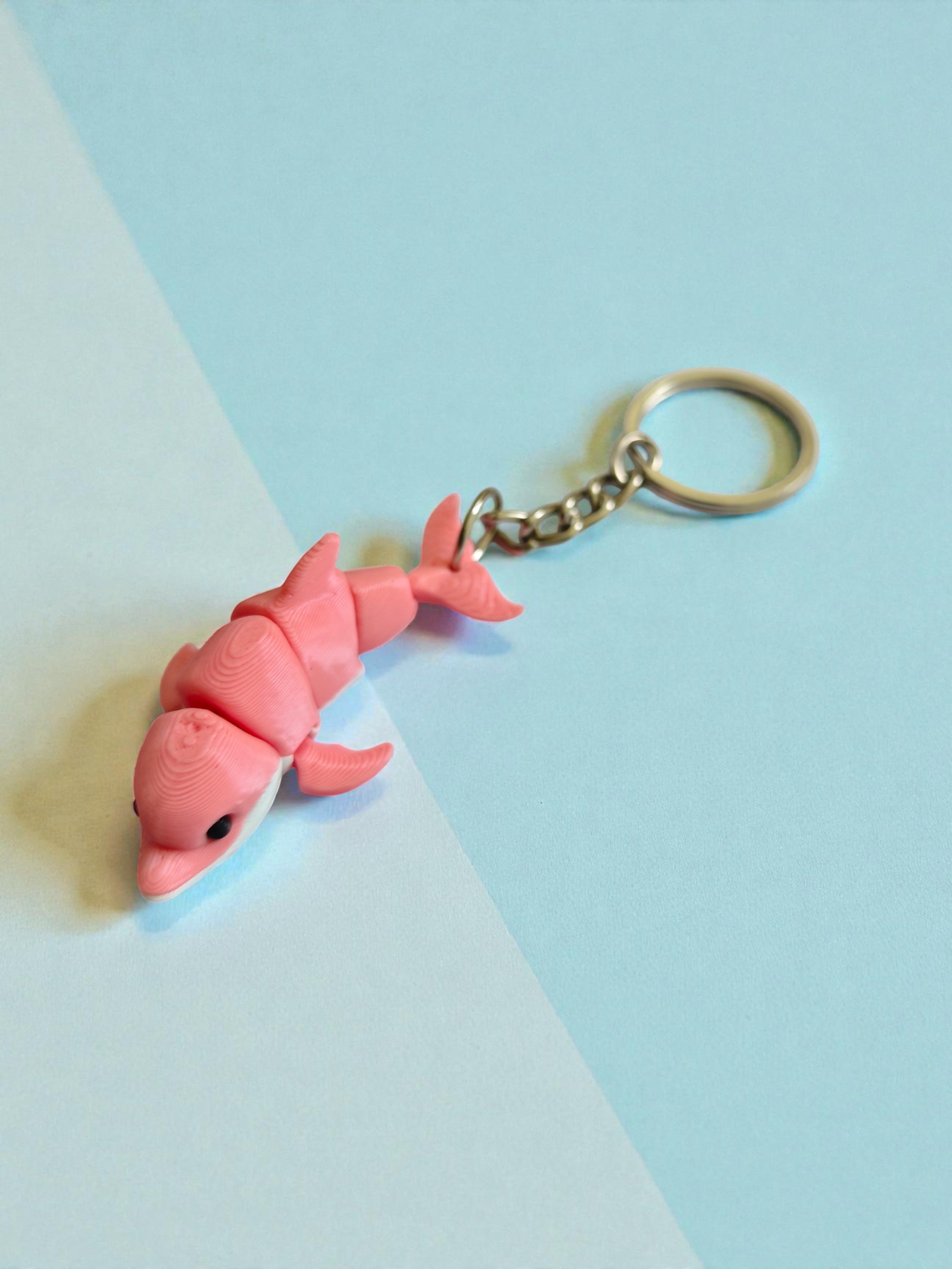 3D Printed white and pink flexi dolphin keychain