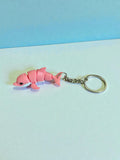 3D Printed white and pink flexi dolphin keychain
